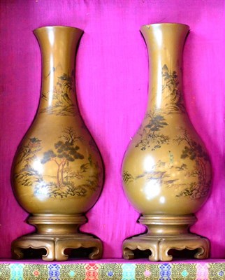 Lot 459 - A pair of Chinese lacquered wood baluster vases with integral stands, painted with landscapes, 25cm