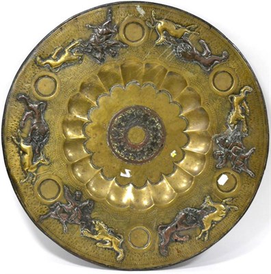 Lot 461 - A Persian brass table top, late 19th century, of circular form, depicting horsemen hunting...