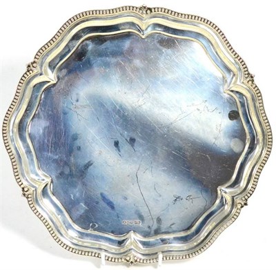 Lot 496 - A George V silver salver, Walker & Hall, Sheffield 1924, shaped circular with bead border and...