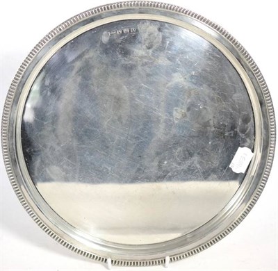 Lot 498 - A George VI silver circular tray, Walker & Hall, Sheffield 1943, with egg and dart type border,...