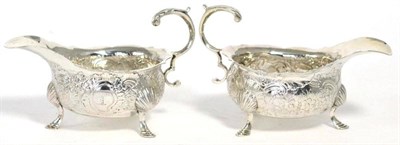 Lot 507 - A matched pair of George II / Victorian silver sauceboats, the first maker's mark indistinct,...