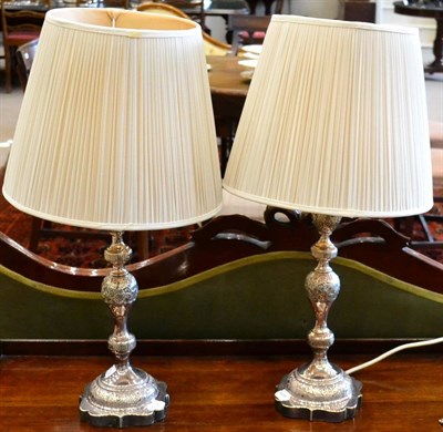 Lot 511 - A pair of Edwardian silver candlesticks converted to table lamps, London 1901, with foliate...