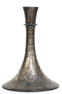 Lot 520 - ^ A Persian inlaid white metal candlestick in 15th century style of swept circular form,...