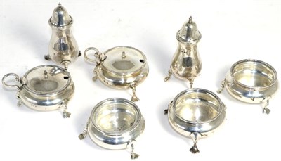 Lot 530 - A seven piece silver condiment set, Mappin & Webb, London, 1926 plain and on pad feet, with...