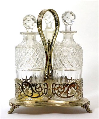 Lot 541 - A Victorian silver plated decanter stand with strap handle on trefoil base with pierced...