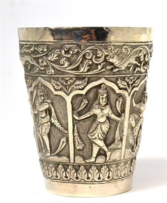 Lot 550 - An Indian white metal beaker, early 20th century, decorated in relief with figures and animals...