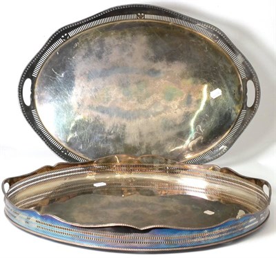 Lot 559 - Two large twin-handled silver plated trays, both with pierced gallery, 61cm and 62cm wide...