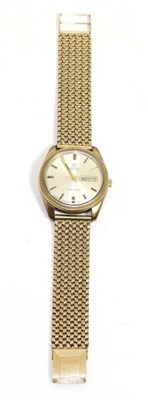 Lot 560 - A 9ct gold automatic day/date centre seconds wristwatch, signed Omega, model: Seamaster, circa...