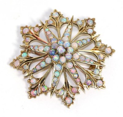 Lot 586 - A 15 carat gold opal star brooch/pendant, eight radial arms spaced by trefoil clusters and set...