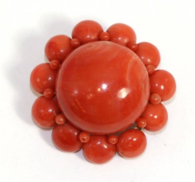 Lot 601 - A coral brooch, a large coral cabochon within a border of coral beads, measures 3.8cm in diameter