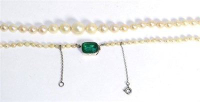 Lot 602 - A cultured pearl necklace, a single strand of graduated cultured pearls knotted to a green...