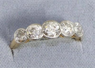 Lot 610 - A diamond five stone ring, graduated old cut diamonds in rubbed over settings, total estimated...