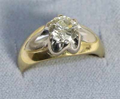 Lot 613 - An 18 carat two colour gold diamond solitaire ring, a round brilliant cut diamond in a white...