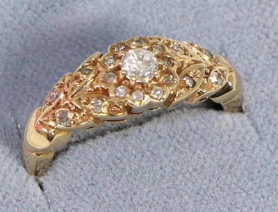 Lot 614 - A diamond ring, a round brilliant cut diamond in a yellow claw setting within an eight-cut...