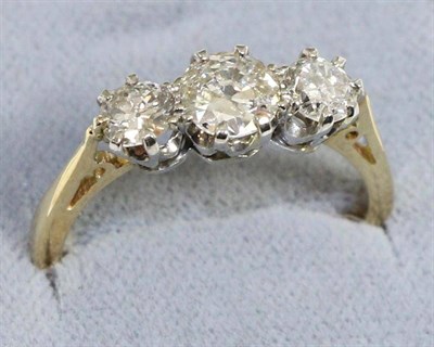 Lot 622 - A diamond three stone ring, graduated old cut diamonds in claw settings, to knife edge...