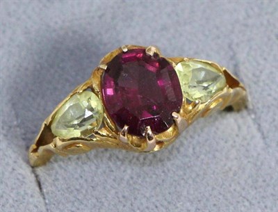 Lot 627 - A garnet and chrysoberyl ring, an octagonal cut garnet spaced by two oval cut chrysoberyl in...