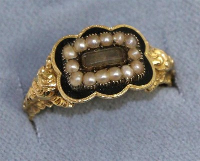 Lot 628 - A George IV 18 carat gold enamel and seed pearl mourning ring, a central glazed plaque within a...