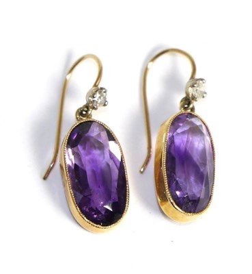 Lot 633 - A pair of amethyst and diamond drop earrings, an eight-cut diamond suspends an oval cut amethyst in