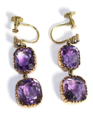 Lot 634 - A pair of amethyst drop earrings, a small round cut amethyst suspends two larger amethyst drops, in