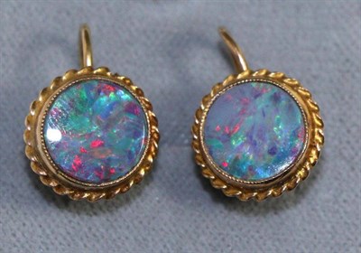 Lot 635 - A pair of black opal earrings, circular black opals within a rope frame, with screw back...