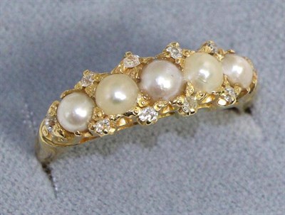 Lot 640 - A pearl and diamond ring, five pearls in a yellow carved setting with old cut diamond accents,...