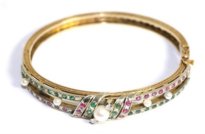 Lot 650 - A ruby, emerald, diamond and cultured pearl bangle, a cultured pearl between two round...