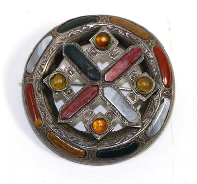 Lot 655 - A Scottish hardstone brooch, a central cross motif within a circular frame and set throughout...