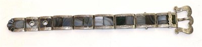 Lot 656 - A Scottish hardstone buckle bracelet, rectangular links inset with hardstone plaques to chased...