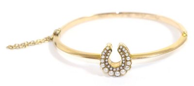 Lot 659 - A seed pearl set horseshoe bangle, a horseshoe with two rows of graduated seed pearls, to a...