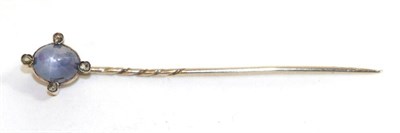 Lot 662 - A star sapphire and diamond stick pin, a blue star sapphire on a yellow rubbed over setting...