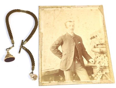 Lot 670 - A Victorian hairwork albert, a thick braided cord with gilt mounts, t-bar and clip, suspending...