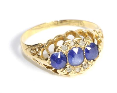 Lot 679 - An 18 carat gold sapphire and diamond ring, three oval cut sapphires with rose cut diamond...