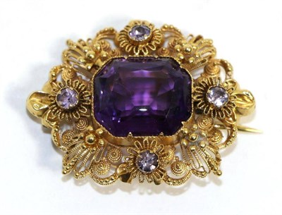 Lot 683 - An amethyst brooch, an octagonal cut amethyst in a yellow collet setting, within a cannetille...