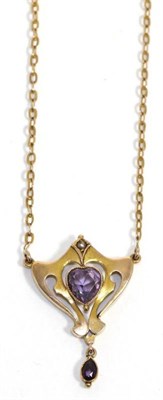 Lot 690 - An Art Nouveau amethyst necklace, a heart cut amethyst in a yellow milgrain setting, within a...