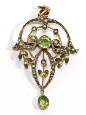 Lot 693 - An Art Nouveau peridot and seed pearl brooch/pendant, a round cut peridot in a yellow milgrain...