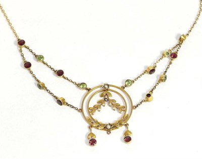 Lot 697 - An Edwardian peridot and garnet necklace, two rows of alternating round cut peridots and garnets in