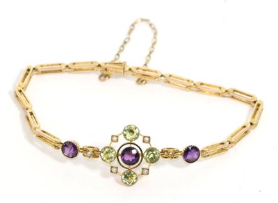 Lot 698 - An Edwardian peridot, amethyst and seed pearl bracelet, a round cut amethyst in a circular...