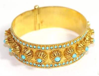 Lot 705 - An Etruscan style turquoise set bangle, set in the round with round cut turquoise in cannetille...