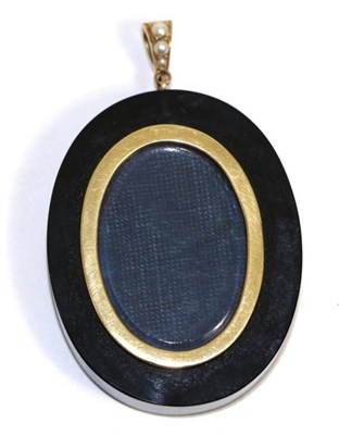 Lot 707 - An onyx pendant, an oval onyx with glazed locket centre, to a pearl set bail, measures 5.8cm by...