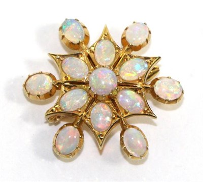 Lot 711 - An opal star brooch/pendant, round and oval cut opals in yellow collet settings with six opal...