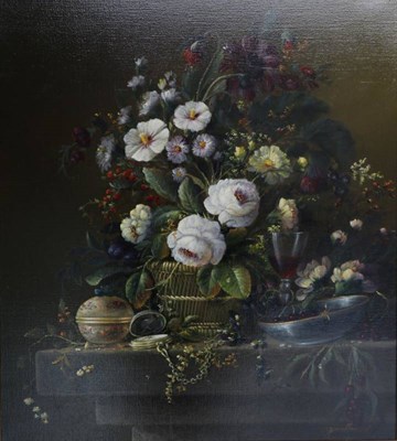 Lot 1110 - Thomas F Heesakkers (20th century) Dutch, Still life of assorted flowers in a basket on a stone...