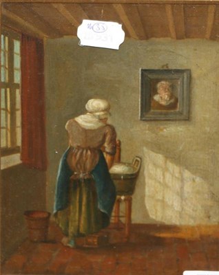 Lot 1246 - In the Dutch Style (19th century) A lady washing clothes in an interior, oil on panel, together...