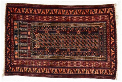 Lot 1335 - A Balouch prayer rug, West Afghanistan, the narrow indigo field beneath multiple Mihrabs...