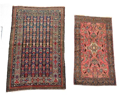 Lot 1339 - A Kurdish rug, North West Iran, the coral pink field of scrolling vines centred by an ivory...