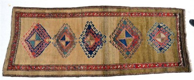 Lot 1340 - A Meskin gallery rug, North West Iran, the plain camel field with a column of latch hook medallions