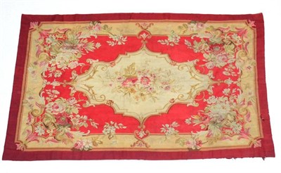 Lot 1341 - A mid 19th century Aubusson carpet, Central France, the pillar box red field with central...