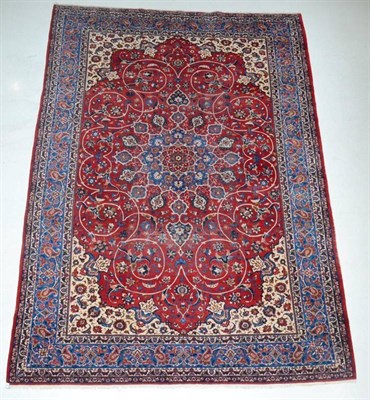 Lot 1342 - A Nejafabad Isfahan carpet, Central Iran, the blood red field of scrolling vines and sky blue...