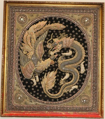 Lot 1345 - A South East Asian embroidery panel worked in various stitches and depicting a dragon and...