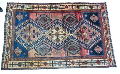 Lot 1346 - A South West Iranian Tribal rug, the abrashed field with rows of latch hook medallions enclosed...