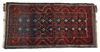 Lot 1353 - Balouch rug, Khorasan, circa 1900, the midnight blue field with columns of stylised flowerheads...